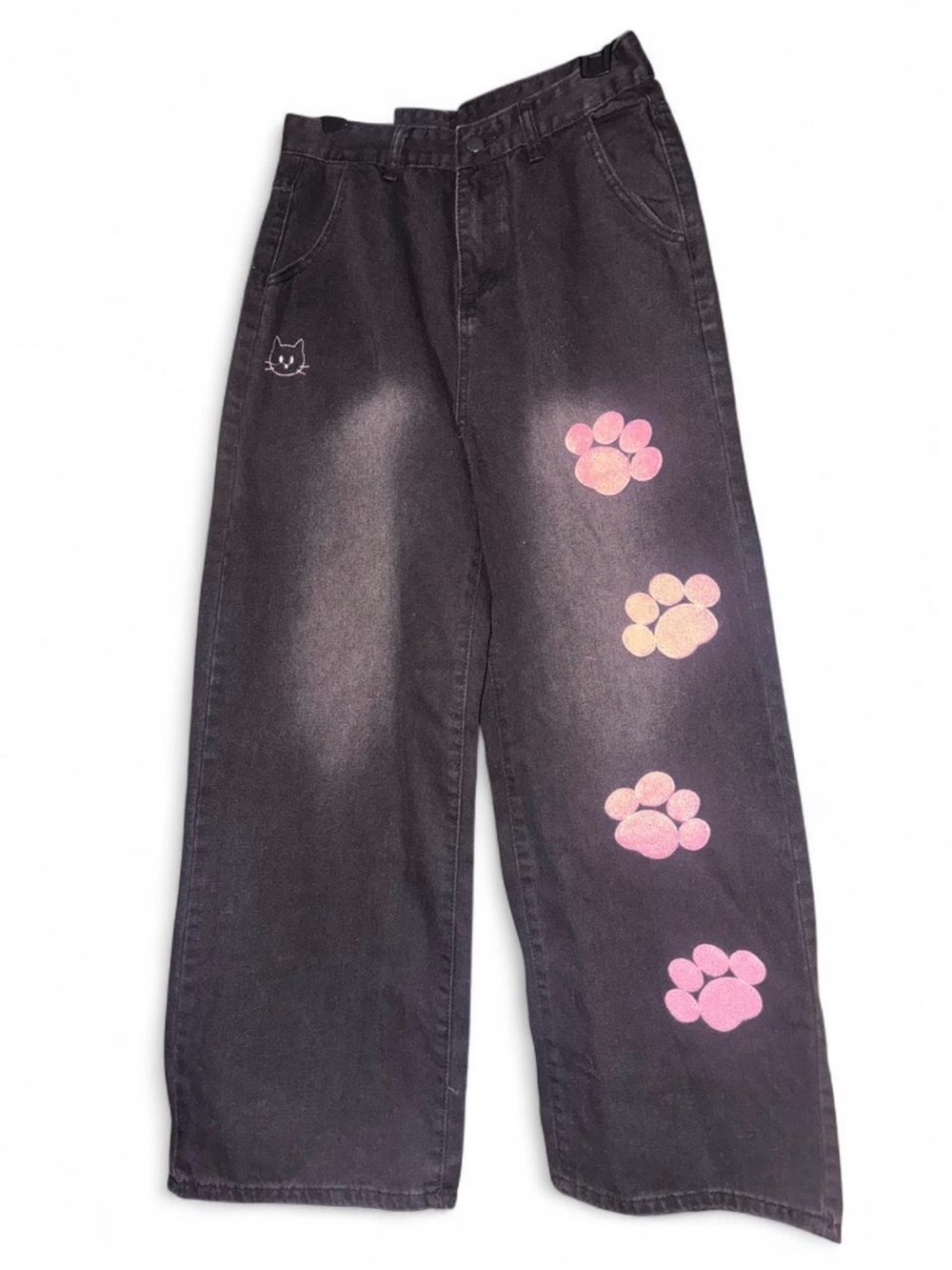 Black jeans with pink paw prints